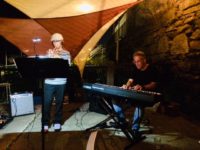 Logan playing trumpet at Cafemantic with his dad accompanying on piano.