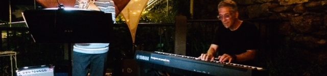 Logan playing trumpet at Cafemantic with his dad accompanying on piano.