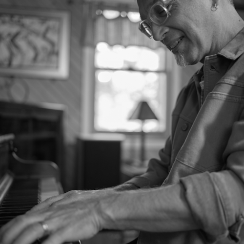 Earl MacDonald playing the piano at home.