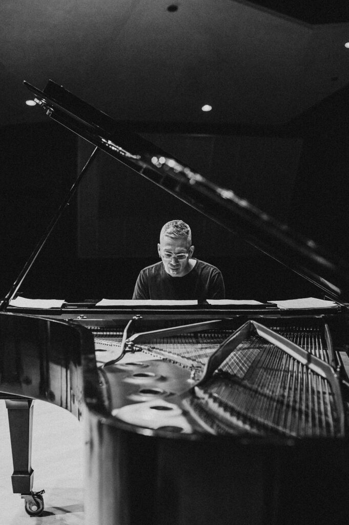 Earl MacDonald, jazz pianist and composer, rehearsing on a Steinway grand piano